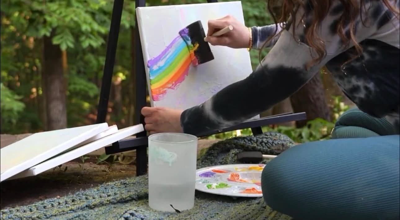 Artist sketching initial composition on canvas